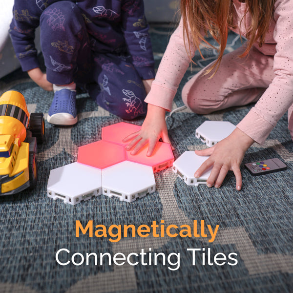 Children playing with magnetic connecting tiles on a carpeted floor. SnapTap_Listing